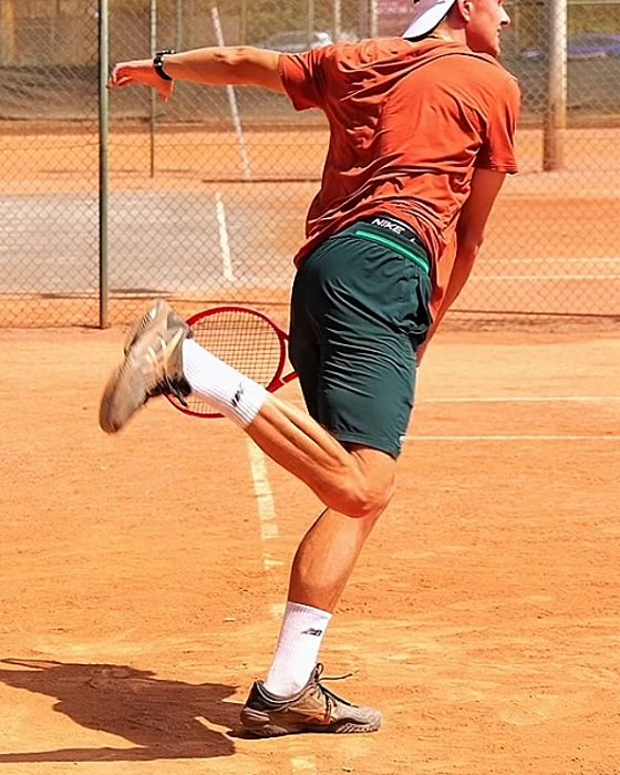 Pavel Viks landing on his front foot inside the baseline