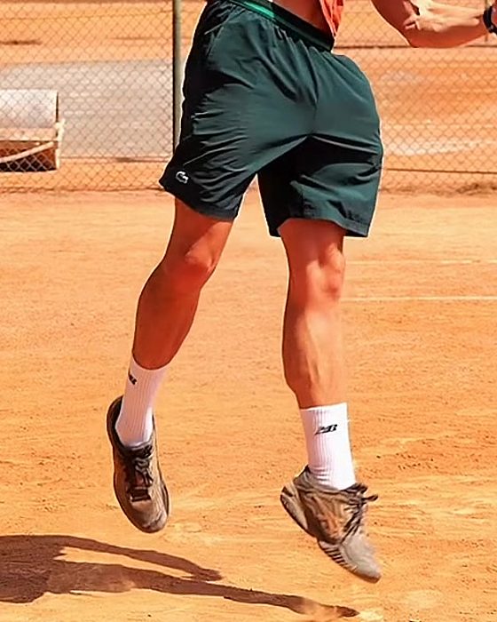 Pavel Viks driving up off the ground into the serve