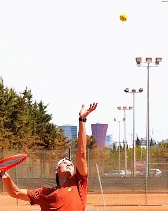 Pavel Viks releasing the toss, the ball rising high above his head